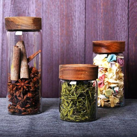 Screw-capped jars with acacia wood screw on threaded lids