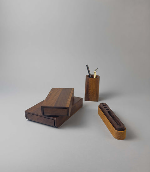 Wooden desk storage accessories including hidden portable desk drawers, a sold wood penholder cup and a double layer wooden pen organiser with holes. 